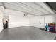 Spacious garage with epoxy flooring, ample storage space, and a convenient access door at 3243 Fountaintree Ave, Henderson, NV 89044