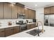 A close up of a modern kitchen with stainless steel appliances and stone countertops at 3243 Fountaintree Ave, Henderson, NV 89044