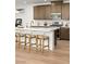 Close up of a kitchen with a large island with seating and stainless steel appliances at 3243 Fountaintree Ave, Henderson, NV 89044