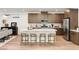 Contemporary kitchen featuring a large island with seating and sleek stainless steel appliances at 3243 Fountaintree Ave, Henderson, NV 89044