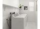 Clean laundry room featuring modern washer and dryer, white shelving, and stylish tile flooring at 3243 Fountaintree Ave, Henderson, NV 89044