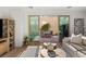 Inviting living room featuring a sliding glass door to a quaint patio with an outdoor dining set at 3243 Fountaintree Ave, Henderson, NV 89044