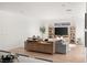Open-concept living room with stylish decor, hardwood floors, and modern entertainment center at 3243 Fountaintree Ave, Henderson, NV 89044