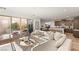 Cozy living room with a plush sofa, neutral tones, and a view of the outdoor patio and kitchen at 3243 Fountaintree Ave, Henderson, NV 89044