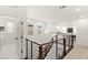 Upstairs loft with wood and metal railing, open space, and natural light at 3243 Fountaintree Ave, Henderson, NV 89044