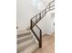 Carpeted staircase with modern wood and metal railing and open landing at 3243 Fountaintree Ave, Henderson, NV 89044
