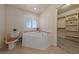 This bathroom features a large soaking tub next to a window and a toilet next to the entrance to the walk-in closet at 3450 Oakleaf Ave, Pahrump, NV 89048
