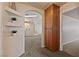 A view through the entryway of the home's arched hallway with built-in shelving and an additional doorway at 3450 Oakleaf Ave, Pahrump, NV 89048