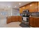 Bright and open kitchen featuring stainless steel appliances, tiled backsplash, and ample counter space at 3450 Oakleaf Ave, Pahrump, NV 89048