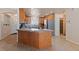 Well-lit kitchen with wood cabinets, granite countertops, and stainless steel appliances at 3450 Oakleaf Ave, Pahrump, NV 89048