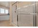 This bathroom features a glass-enclosed shower with a built-in seat next to the large soaking tub at 3450 Oakleaf Ave, Pahrump, NV 89048