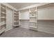 The walk-in closet has carpeted floors and is organized with shelving and wood poles for hanging clothes at 3450 Oakleaf Ave, Pahrump, NV 89048