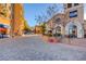 Street view of a retail space with outdoor dining and pedestrian walkway at 36 Via Vasari # 201, Henderson, NV 89011