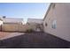 The backyard features gravel landscaping with block wall fencing and a gate at 3745 Saint Peter Ct, North Las Vegas, NV 89031