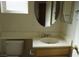 Bright bathroom with tile floors, built-in vanity, and round mirror over sink at 3745 Saint Peter Ct, North Las Vegas, NV 89031