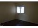 Well-lit bedroom with neutral walls and dark laminate flooring at 3745 Saint Peter Ct, North Las Vegas, NV 89031