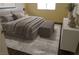 Staged bedroom featuring a large bed, neutral tones, and natural light at 3745 Saint Peter Ct, North Las Vegas, NV 89031