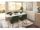 Staged dining area with modern table, chairs, and natural light from the door to the backyard at 3745 Saint Peter Ct, North Las Vegas, NV 89031
