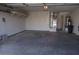 Spacious garage with concrete floor and storage shelf and utility closet at 3745 Saint Peter Ct, North Las Vegas, NV 89031