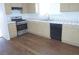 Kitchen featuring stainless steel appliances, laminate flooring, and tile countertops at 3745 Saint Peter Ct, North Las Vegas, NV 89031