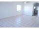 Spacious living room with tile flooring, large window, and neutral paint at 3745 Saint Peter Ct, North Las Vegas, NV 89031