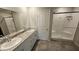 Bathroom featuring double sinks, granite counters and tiled walk-in shower at 3816 Seyfert Ave, North Las Vegas, NV 89084