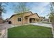 Backyard featuring a manicured lawn, an outdoor kitchen and sitting area at 3870 Valles Caldera Ct, Las Vegas, NV 89118