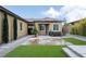 Backyard featuring lush artificial turf, mature trees and a water feature at 3870 Valles Caldera Ct, Las Vegas, NV 89118