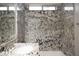 Bathroom with double sinks, decorative backsplash, granite countertop, and walk-in shower at 3870 Valles Caldera Ct, Las Vegas, NV 89118