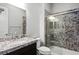 Bathroom featuring granite counters, decorative shower, and chrome fixtures at 3870 Valles Caldera Ct, Las Vegas, NV 89118