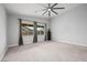 Large bedroom featuring plush carpet, ceiling fan, and plenty of natural light at 3870 Valles Caldera Ct, Las Vegas, NV 89118