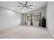 Spacious bedroom with neutral carpet, ceiling fan, and large windows at 3870 Valles Caldera Ct, Las Vegas, NV 89118
