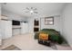 Cozy bedroom with neutral colors, a ceiling fan, and an attached home office area at 3870 Valles Caldera Ct, Las Vegas, NV 89118