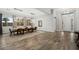 Bright dining room with wood floors, modern lighting, and large windows at 3870 Valles Caldera Ct, Las Vegas, NV 89118