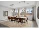 Bright dining room with wood floors, modern lighting, and large windows at 3870 Valles Caldera Ct, Las Vegas, NV 89118