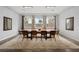 Bright dining room with wood floors, modern lighting, and large windows at 3870 Valles Caldera Ct, Las Vegas, NV 89118