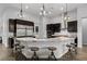 Stylish kitchen with stainless steel appliances, granite countertops, a central island, and modern pendant lighting at 3870 Valles Caldera Ct, Las Vegas, NV 89118