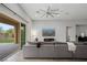 Bright living room featuring a large sectional sofa and sliding glass doors to the backyard at 3870 Valles Caldera Ct, Las Vegas, NV 89118