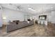 Open floor plan featuring living room, kitchen with bar seating, and wood-style tile flooring at 3870 Valles Caldera Ct, Las Vegas, NV 89118
