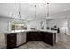 Inviting living area, open floor plan with stainless appliances, granite counters, an island and backyard access at 3870 Valles Caldera Ct, Las Vegas, NV 89118