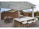 Enjoy outdoor living with a covered patio, built-in grill, sink, and bar seating for relaxing and entertaining at 3870 Valles Caldera Ct, Las Vegas, NV 89118