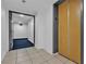 Hallway features tile floors, an elevator, and access to a hallway with blue carpeting and an exit sign at 3930 University Center Dr # 401, Las Vegas, NV 89119