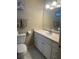 Bright bathroom featuring a single sink vanity, toilet and a framed mirror at 4454 W Desert Inn Rd # B, Las Vegas, NV 89102