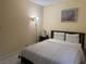 Bright bedroom with neutral walls, tile floor, art, and a comfortable bed at 4454 W Desert Inn Rd # B, Las Vegas, NV 89102