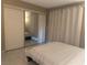 Bedroom featuring a queen-sized bed, a mirrored closet and marble flooring at 4454 W Desert Inn Rd # B, Las Vegas, NV 89102