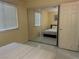 Bedroom with large mirrored closet and a window for natural light at 4454 W Desert Inn Rd # B, Las Vegas, NV 89102