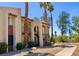 Exterior of a condo building with mature landscaping and a stone walkway at 4454 W Desert Inn Rd # B, Las Vegas, NV 89102