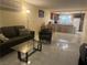 Open living room and kitchen area with marble floors, wood cabinets and bar seating at 4454 W Desert Inn Rd # B, Las Vegas, NV 89102