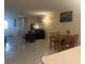 Open-concept living room with tile floor, sofa, dining table, and bright lighting at 4454 W Desert Inn Rd # B, Las Vegas, NV 89102