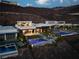 Aerial view of an estate featuring manicured grounds, multiple pools, and a modern home design at 515 Serenity Point Dr, Henderson, NV 89012